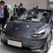 (FILES) In this file photo taken on April 19, 2021, a Tesla model 3 is seen during the 19th Shanghai International Automobile Industry Exhibition in Shanghai. - Tesla reported its first-ever quarterly profit above USD 1 billion on July 26, 2021 as it reiterated its 2021 production targets despite supply chain upheaval. (Photo by Hector RETAMAL / AFP)